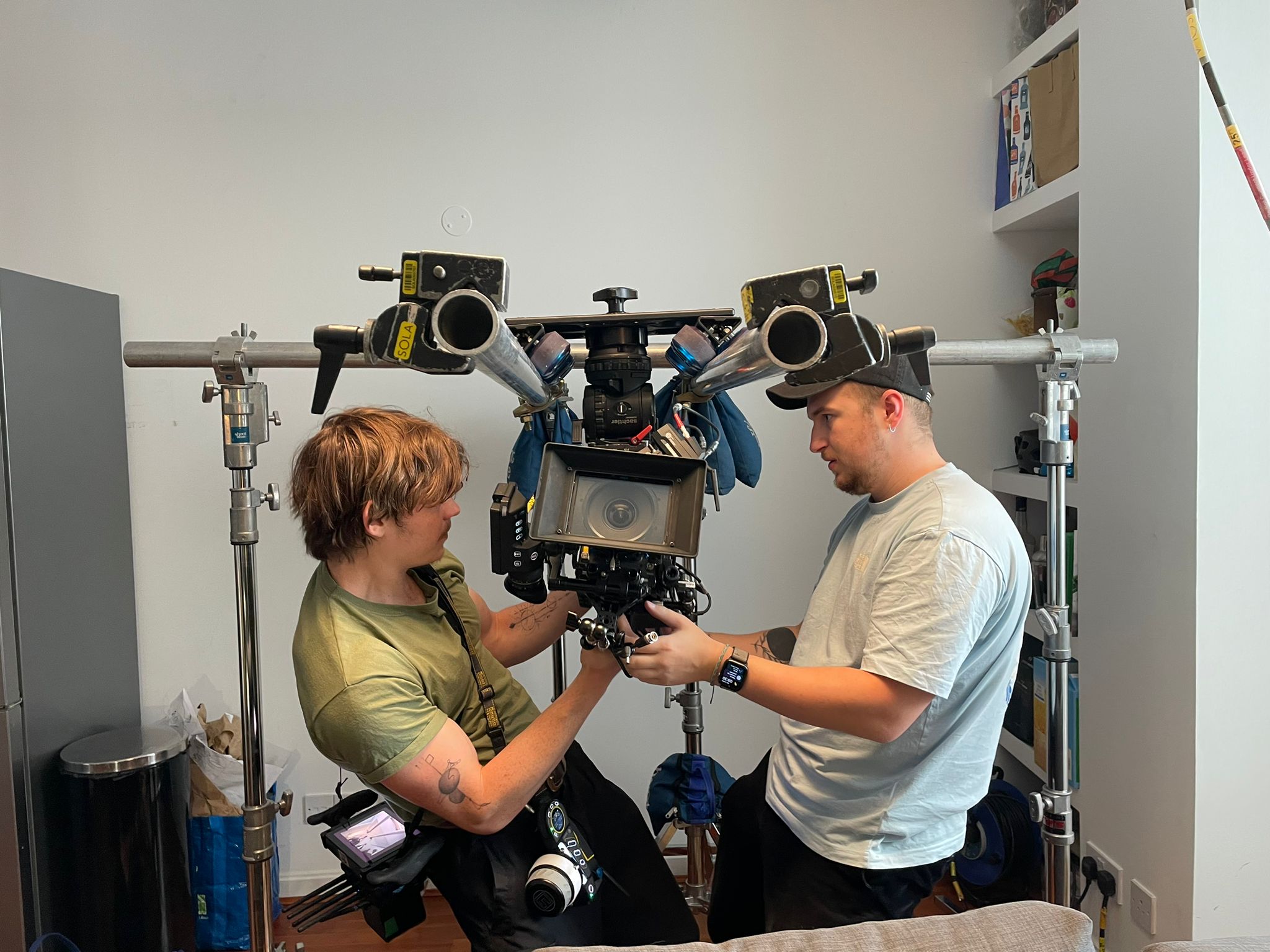Charlie Hedger and another crew member are underslingging a cinema camera to a camera dolly/slider.
